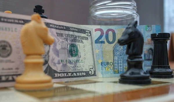 stock image euro and dollar notes playing against each other in the board of war economy