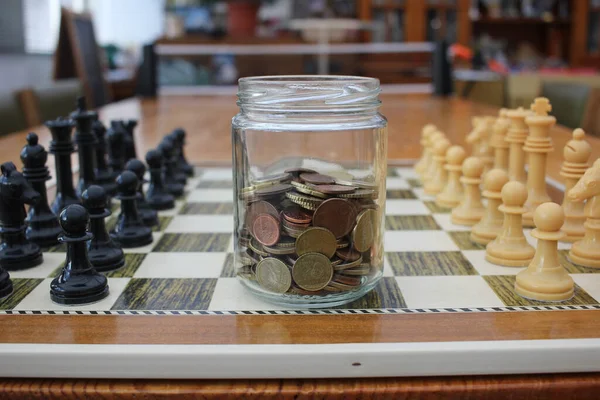 the glass jar of savings on the chessboard of higher interest rates in Europe