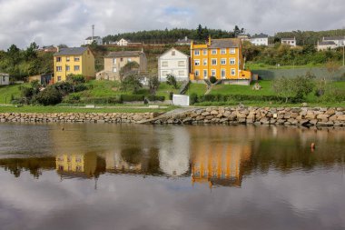 houses in Fazouro, Spain, reflected in the river