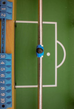 blue table football goal keeper seen from above