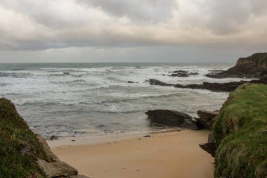 waves and cloudy sky in a Cantabrian beach