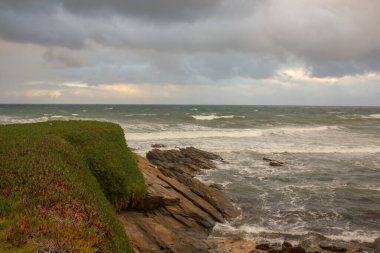 Cantabrian coast in Galicia, Spain, with cloudy sky and waves in the sea