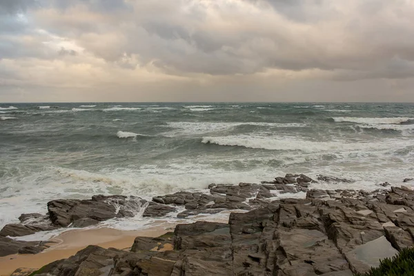 rocks and waves in a cloudy day in the Cantabrian sea