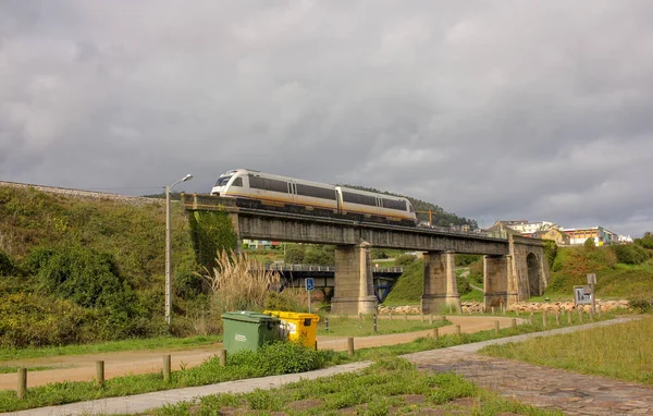 stock image a train crossing a bridge over a river in Foz, Spain