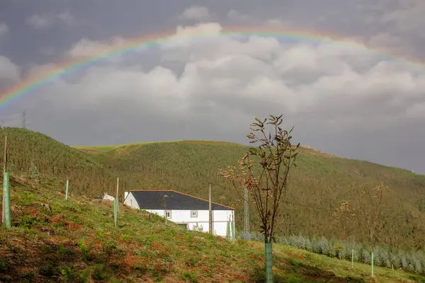 rainbow in the mountains in a cloudy day