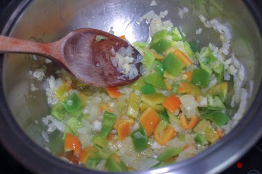 Tahta kaşıkla Salpicon adında bir salsa sosu karıştırıyorum.