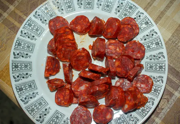 a plate of sliced chorizo to eat with a friend at home