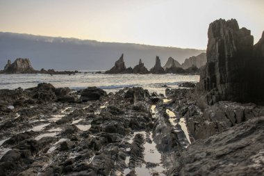 eroded rocks in Gueirua beach at dawn in Asturias, Spain near Cudillero clipart