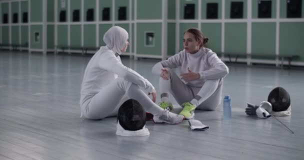 Handheld Shot Full Body Young Female Fencer Sitting Floor Fencing — Stock Video
