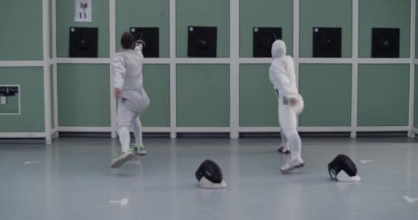 Zoom Handheld Shot Anonymous Diverse Female Fencers White Uniform Practicing — Stock Video