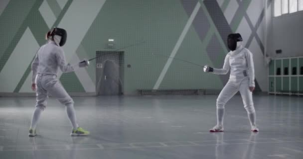 Tracking Shot Female Fencers Uniform Masks Practicing Attacks Evasion Fencing — Stock Video