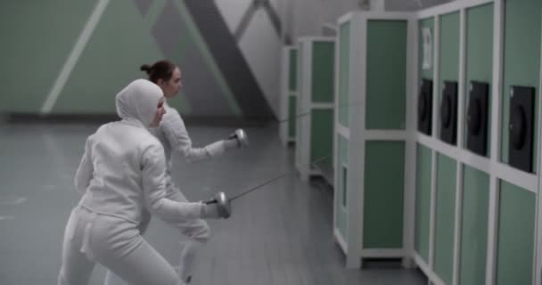Zoom Handheld Tracking Shot Diverse Female Athletes Practicing Strikes Foil — Stock Video