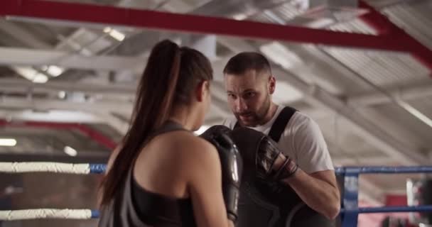 Handheld Shot Bearded Male Instructor Armor Mitts Helping Female Boxer — Stock Video