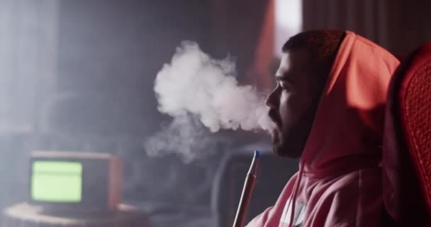 Side View Calm Bearded Millennial Man Sitting Armchair Smoking Hookah — Stockvideo