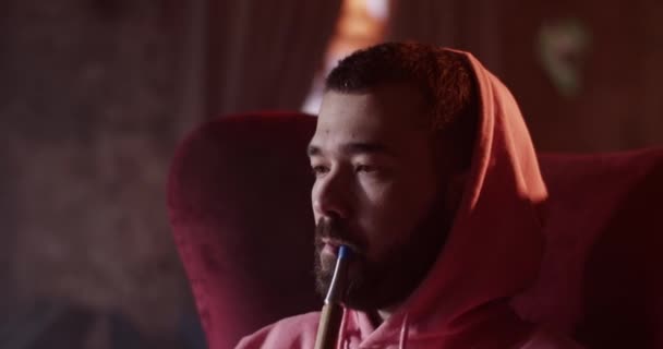 Young Bearded Guy Hoodie Exhaling Hookah Smoke Rings While Having — Stockvideo