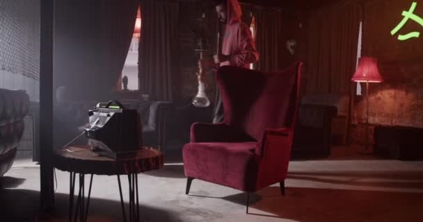 Casual Millennial Guy Entering Room Hookah Taking Seat Armchair Starting — Video