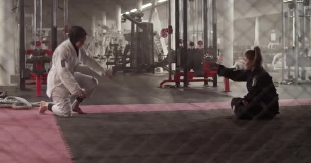 Handheld Shot Muslim Wrestler Doing Headstand Drill Female Instructor Sitting — стокове відео