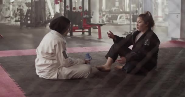 Handheld Shot Diverse Women Sitting Floor Barrier Speaking Each Other — Stock videók