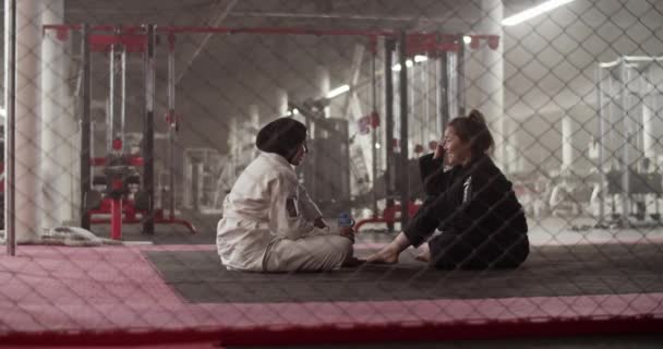 Handheld Shot Diverse Women Sitting Floor Barrier Speaking Each Other — Videoclip de stoc