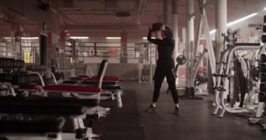 Müslüman sporcunun ağırlık kaldırırken ve spor salonunda ağırlık kaldırırken elde çekilmiş bir fotoğrafı.