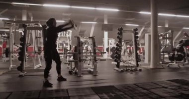 Müslüman sporcunun ağırlık kaldırırken ve spor salonunda ağırlık kaldırırken elde çekilmiş bir fotoğrafı.