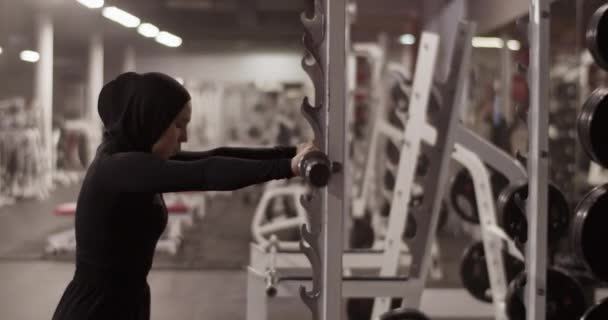 Handheld Tracking Shot Muslim Female Athlete Hijab Putting Barbell Rack — Stok video