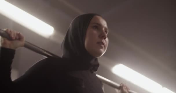 Tracking Shot Muslim Female Athlete Barbell Shoulders Breathing Squatting Intense — Stock Video