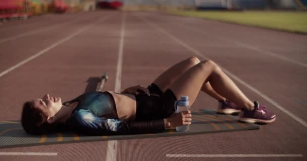 Full Body Handheld Shot Young Exhausted Female Sprinter Sportswear Lying — Stock Video