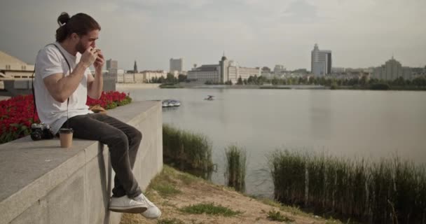 Кишеньковий Знімок Молодого Чоловічого Туриста Який Сидить Бетонному Кордоні Поблизу — стокове відео