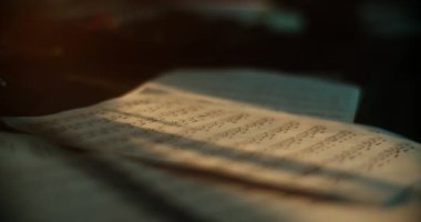 Ses kayıt stüdyosundaki müzik kağıtlarının üzerine düşen güneş ışığının yakın plan çekimi. 