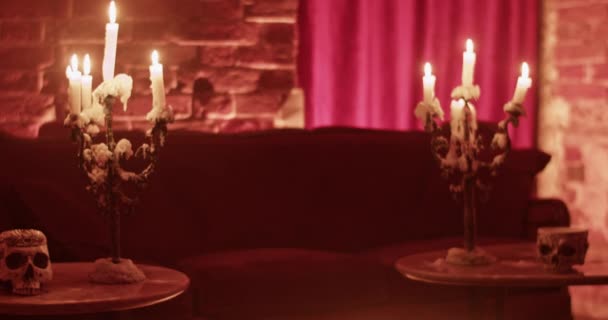 죽음의 집에서 거실에서 테이블에 불타는 양초가있는 불타는 두개골 — 비디오
