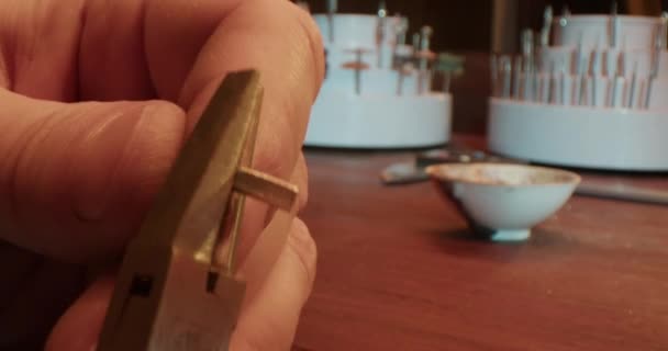 Real Time Crop Anonymous Male Goldsmith Creating Silver Ring Pliers — Stock video