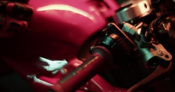 暗いガレージでハンドルバーでエンジンを開始する保護手袋で匿名のプロのオートバイのクロップアップハンドヘルドショット — ストック動画