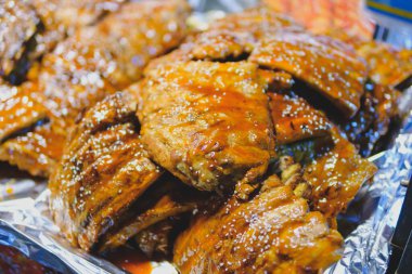 Grilled pork ribs with BBQ sauce on foil