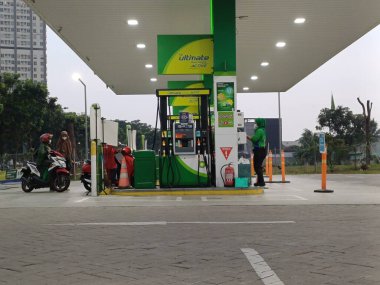 A contemporary BP petrol station in Tangerang, Indonesia, offers motorists a range of fuel options and convenient services. Its inviting design and vibrant branding create a welcoming environment for travelers on the go. clipart