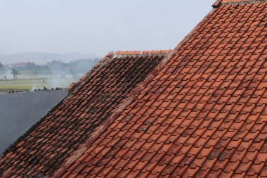 House roof tiles that have been installed for a long time clipart