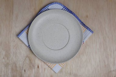 Boş tabak, tahta üstüne bez.