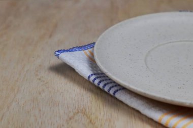 Boş tabak, tahta üstüne bez.