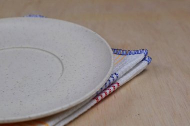 Boş tabak, tahta üstüne bez.