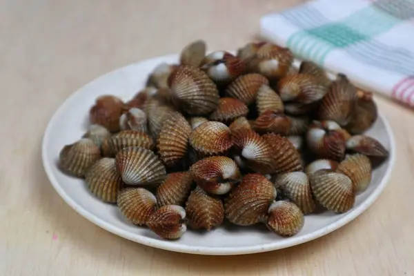 Taze midyeler, kaynamış istiridyeler, beyaz bir tabakta servis edilen kolay bir deniz ürünleri tarifi menüsü, kan midyeleri.