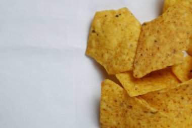 Close up of Crispy corn tortilla nacho chips in wooden plate clipart