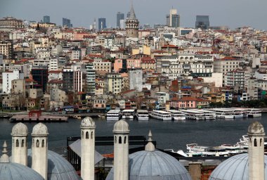 Fotoğrafın merkezinde Galata Kulesi 'nin bulunduğu İstanbul (Türkiye) panoramik manzarası, Süleyman Camii Camii' nin çatısı ve tekneleri ile fırtınalı bir gökyüzüne karşı Haliç Koyu.