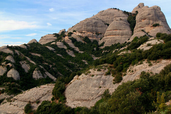 Landscape view of the mountains and the church Ermita de Sant Joan in the foreground in the National park near the monastery of Montserrat near Barcelona, Catalonia, Spain