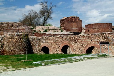 Iznik, Bursa, Turkey - April 15, 2021: Photo with a view of the ancient aqueduct and the Istanbul Gate against a blue sky with clouds in the historical part of the city of Iznik