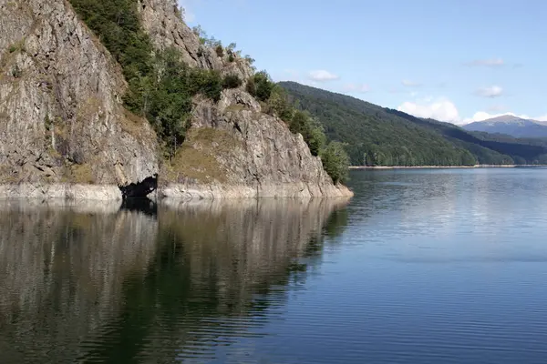 stock image Landscape photo with a view of the mountains and the smooth mirror surface of Lake Vidraru in Romania