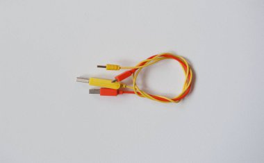Wire node of two cables on a white background. Yellow and orange cables