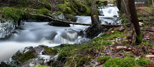 Waterfall in the forest in winter