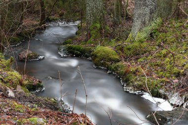 Waterfall in the forest in winter