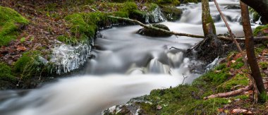 Waterfall in the forest in winter