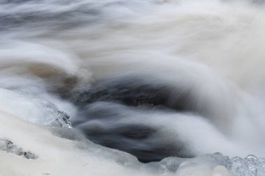 Close-up of water in waterfall in the nature - abstract background